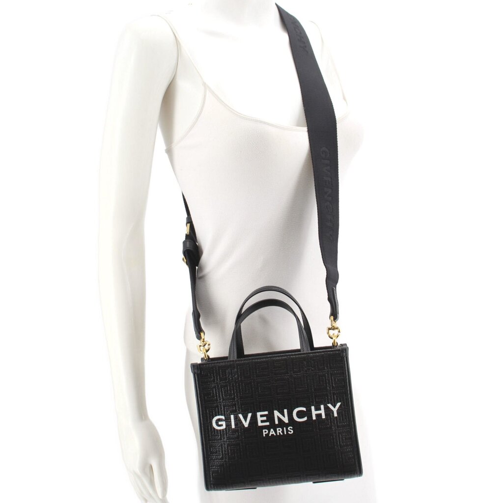 Black GIVENCHY mini G tote crossbody worn at side with adjustable strap