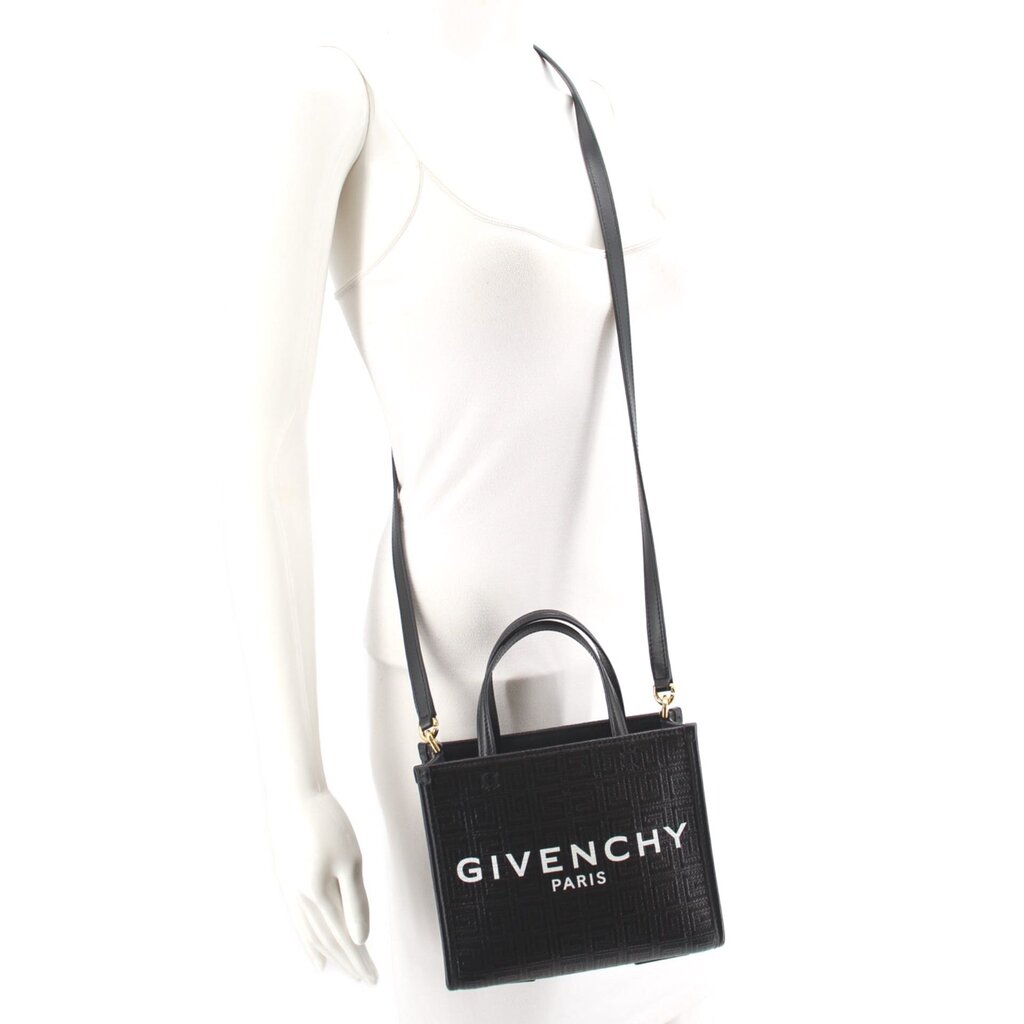 Black GIVENCHY mini tote crossbody with strap worn across shoulder