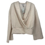 SPANX cream wrap top with a deep V-neck, long sleeves, and a wide hem band
