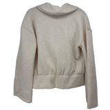 SPANX cream wrap top, back view, with long sleeves and a wide hem band