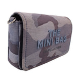 Gray camo mini crossbody bag with “THE MINI BAG” patch and chain strap