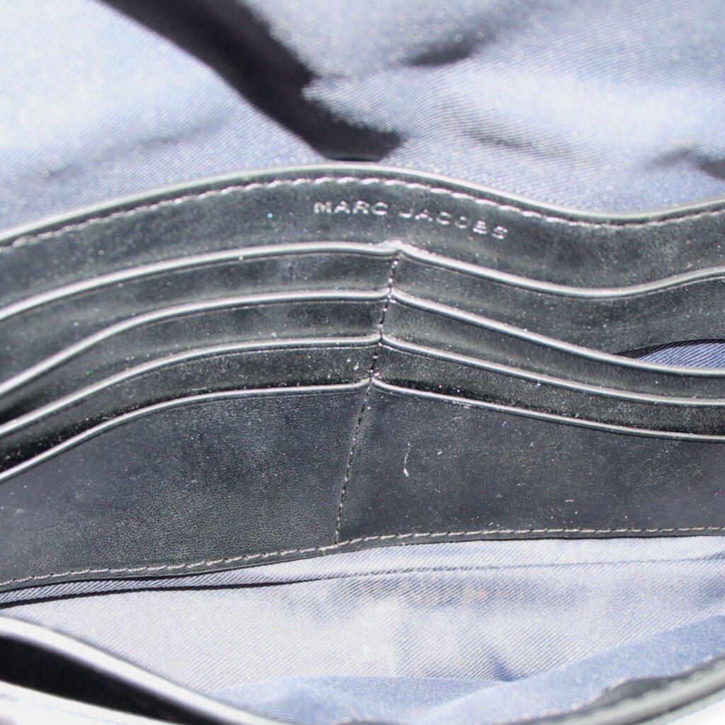 Inside view of gray camo mini bag with stitched lining and black trim