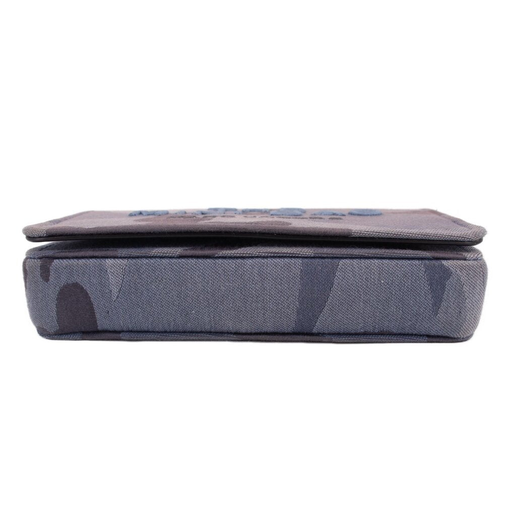 Gray camo mini crossbody bag shown from the top, slim profile