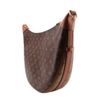 Monogram hobo crossbody bag with tan shoulder strap and gold top hook
