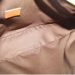Crossbody bag interior lining in tan fabric with stitched seam