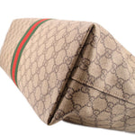 Tote bag corner close-up with beige GG canvas and green-red web stripe
