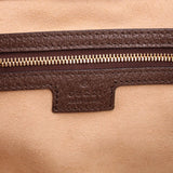 Tote bag close-up of brown zipper tape and leather trim with Gucci label