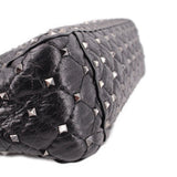 Black quilted leather bag with silver-tone Rockstud details along the edge