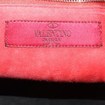 Valentino Garavani label on red fabric lining inside quilted bag