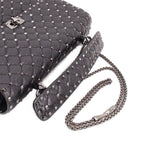 Black quilted bag with silver-tone Rockstud trim and braided chain shoulder strap