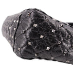 Black quilted leather bag with silver-tone Rockstud pyramid studs and braided trim