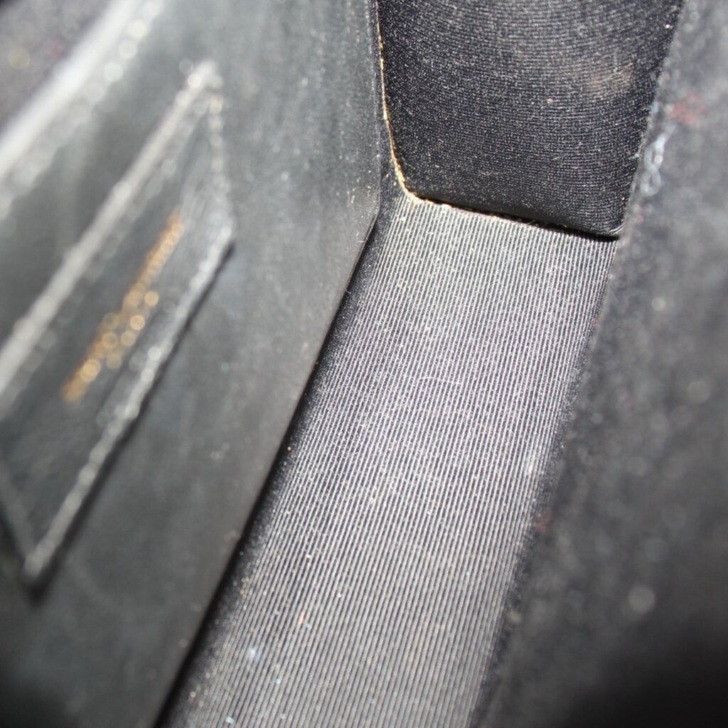 Croc-embossed lining and stitched seam detail inside the flap