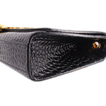Black croc-embossed flap with glossy lining and gold hardware stud