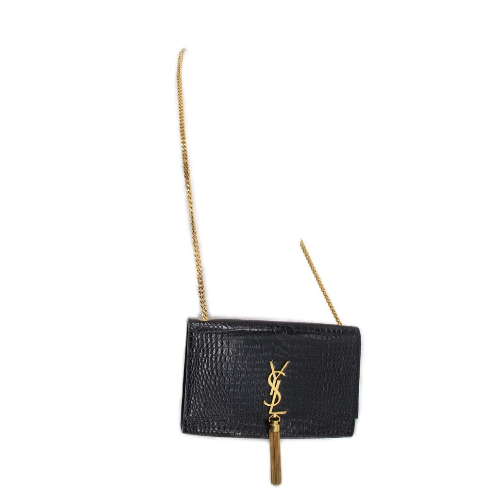 Black leather crossbody bag with YSL logo and tassel, gold chain strap.