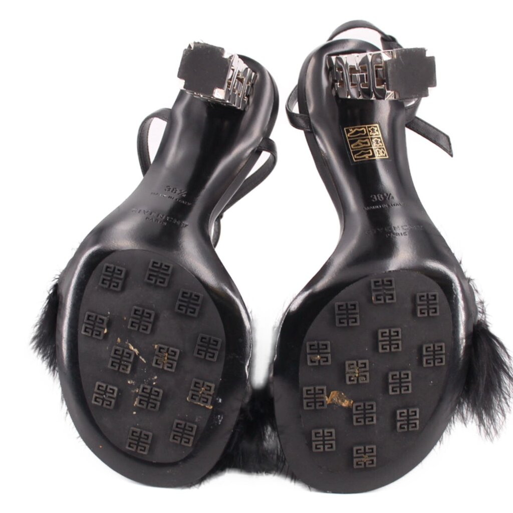 Black feather-trim sandals with logo footbeds and cube hardware on the heels