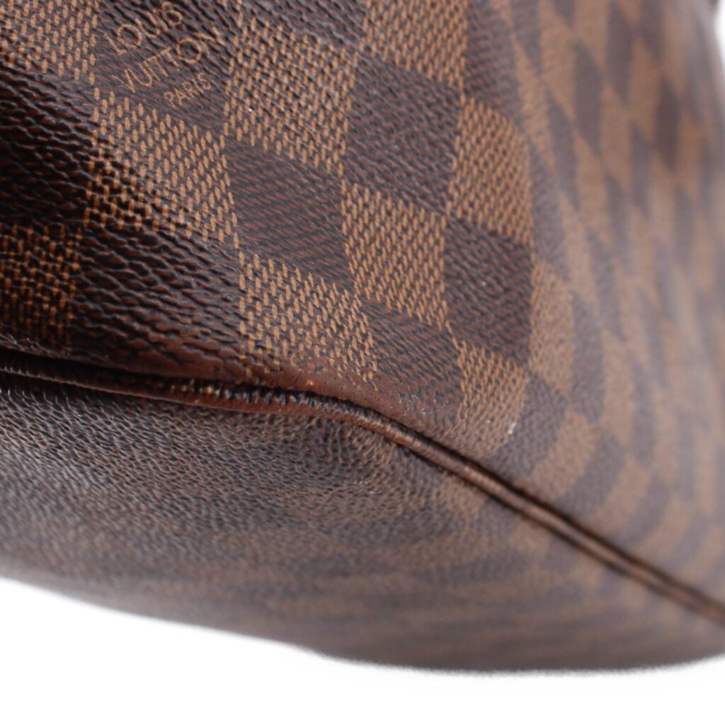 Louis Vuitton Neverfull MM Damier Ebene tote close-up of brown check canvas and leather trim