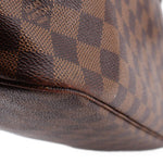 Louis Vuitton Neverfull MM Damier Ebene tote close-up of brown check canvas and leather trim