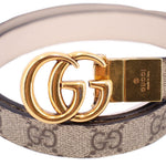 Close-up tan GG monogram belt with gold double-G buckle plate