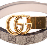 Close-up tan GG monogram belt with gold double-G buckle plate
