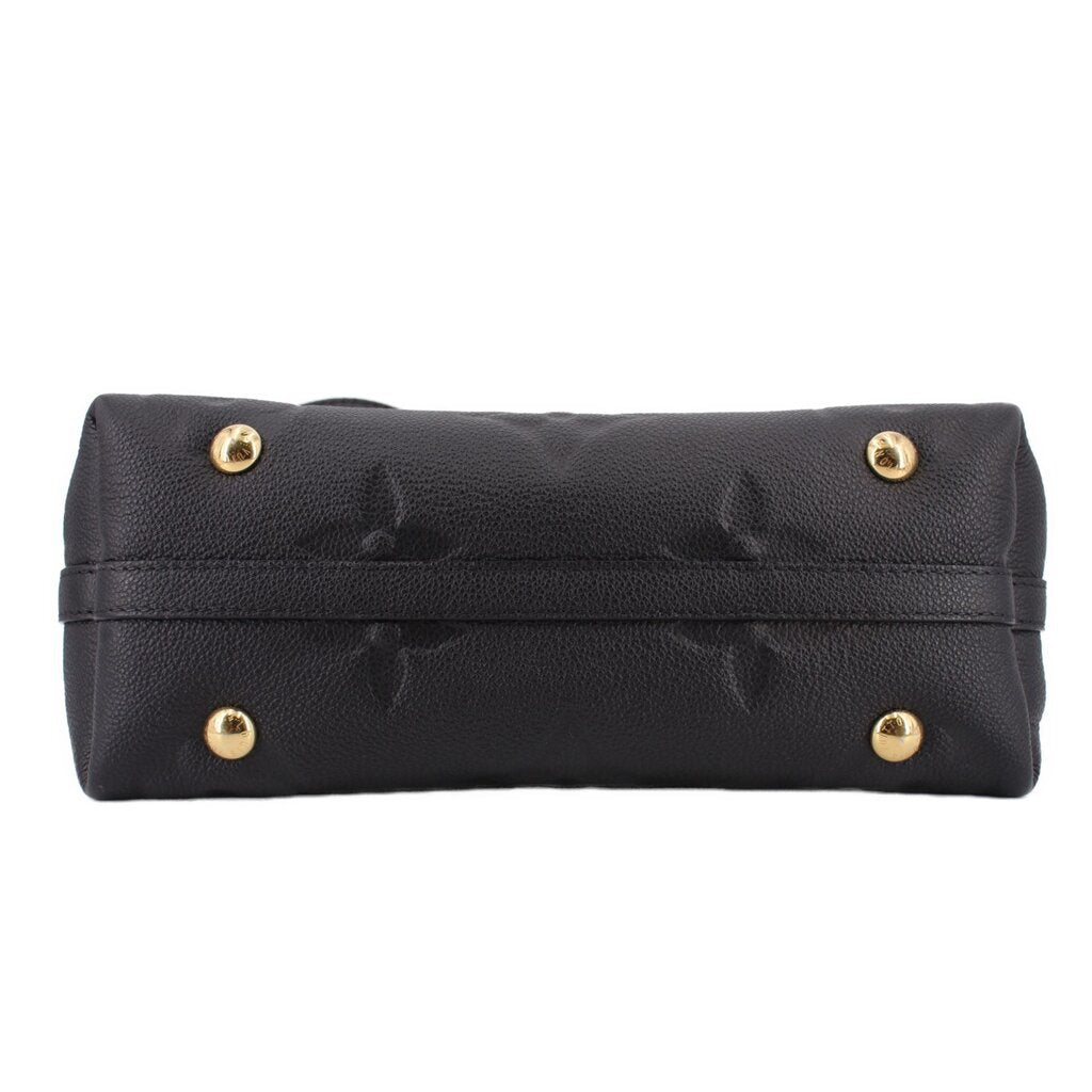 Black monogram top handle bag with gold-tone snap hardware and stitched trim