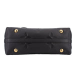 Black monogram top handle bag with gold-tone snap hardware and stitched trim
