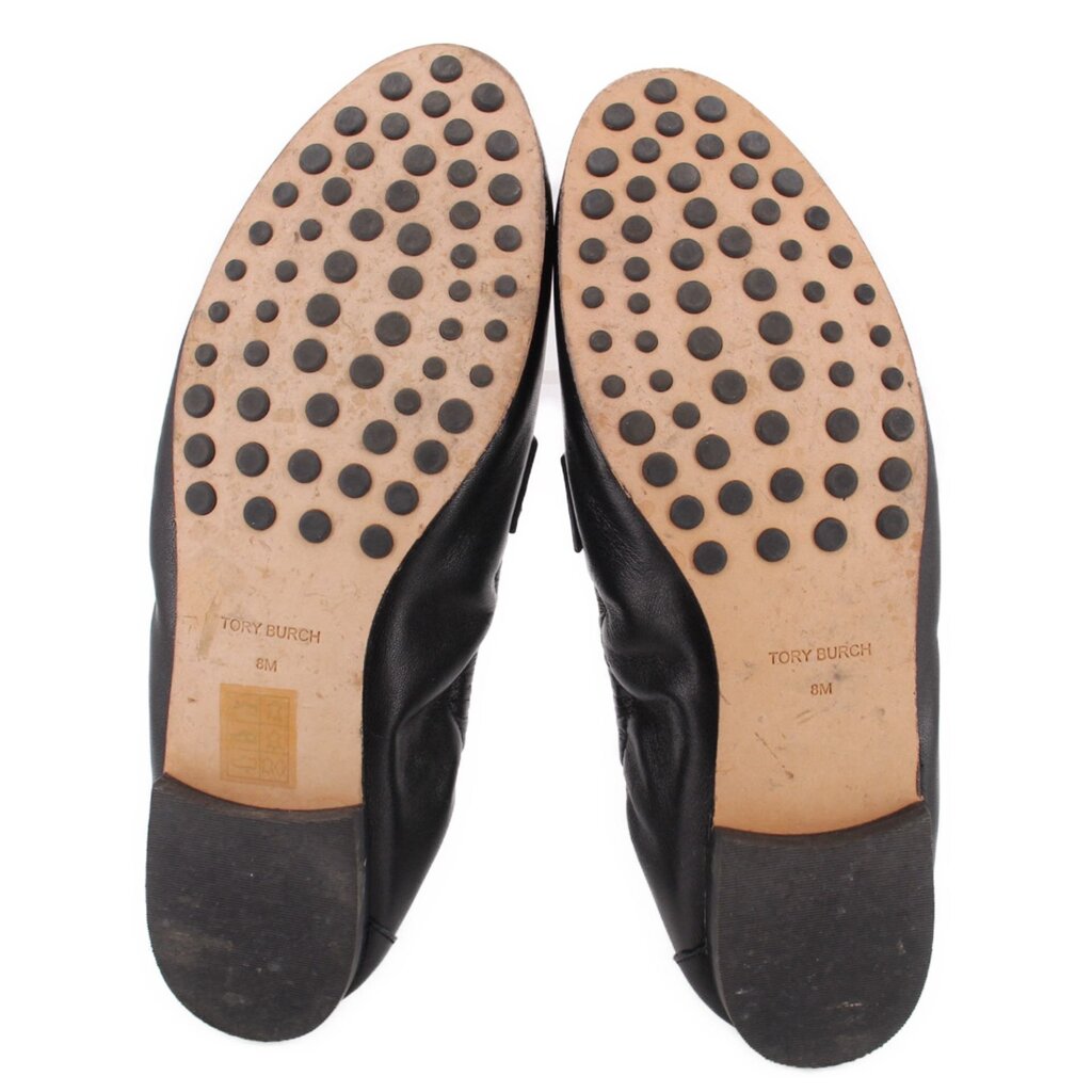 Leather loafer outsoles with circular tread dots; TORY BURCH branding