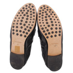 Leather loafer outsoles with circular tread dots; TORY BURCH branding