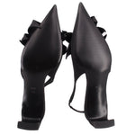 Black satin slingback heels with sculpted heel and knotted bow at toe