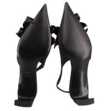 Black satin slingback heels with sculpted heel and knotted bow at toe