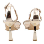 Gold metallic heeled sandals, back view: ankle strap and rhinestone trim