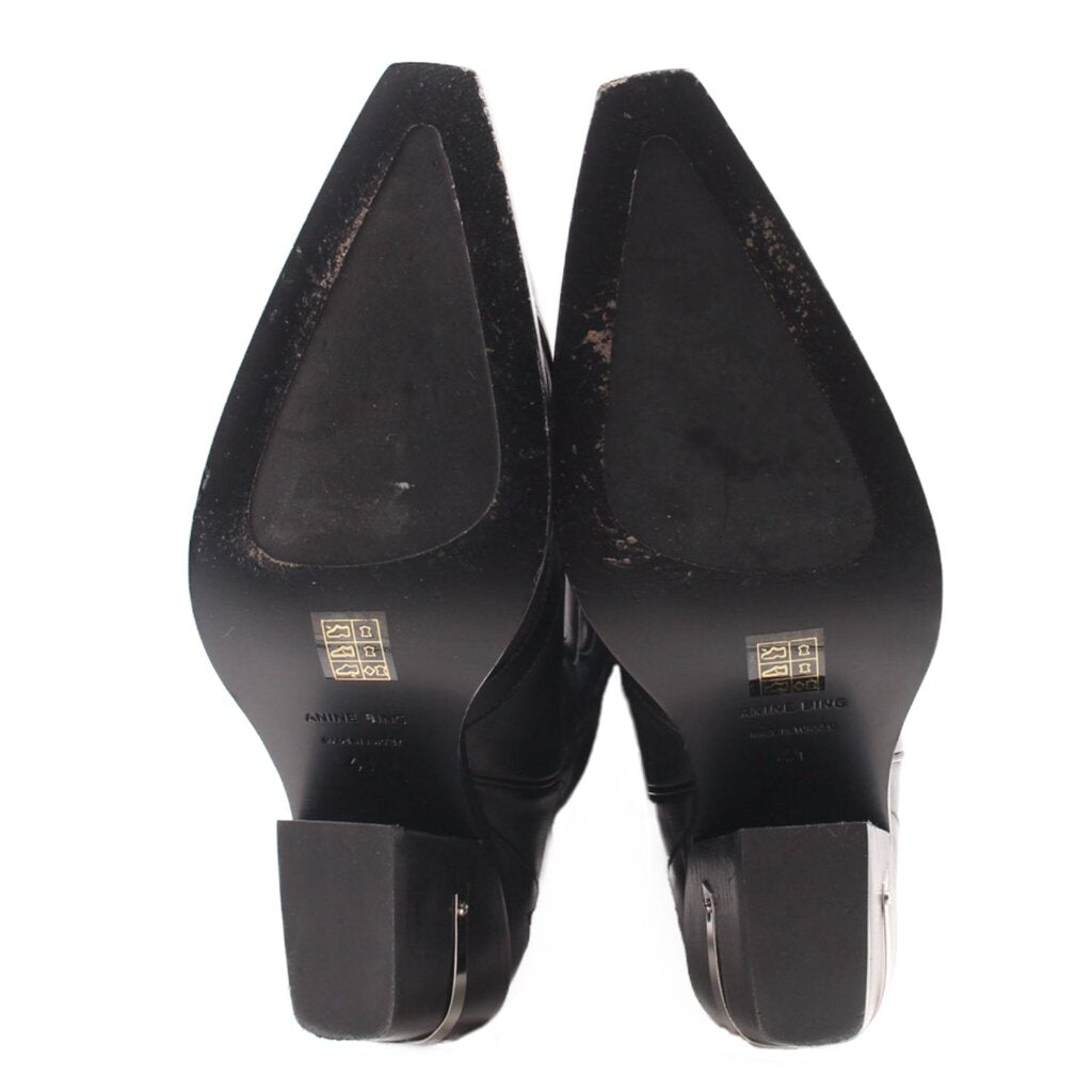 Black cowboy boots heel view with branded insole and side zipper