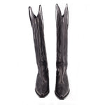 Pair of black cowboy boots with pointed toe, tall shaft, decorative stitching