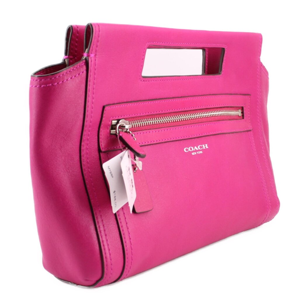 Magenta Coach clutch bag with wrist strap, front zipper pocket, and hanging tag