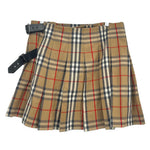 Plaid skirt in tan, red, and dark with front pleats and adjustable side straps