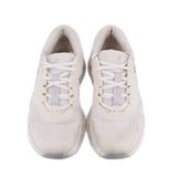 Pair of white lace-up ON Cloudrunner 3 sneakers with breathable mesh panels