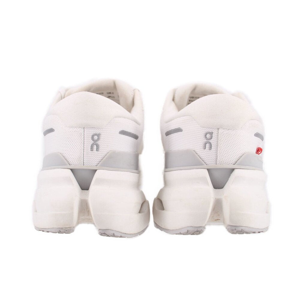 Back view of white ON Cloudrunner 3 sneakers with cushioned heel and lace-up closure