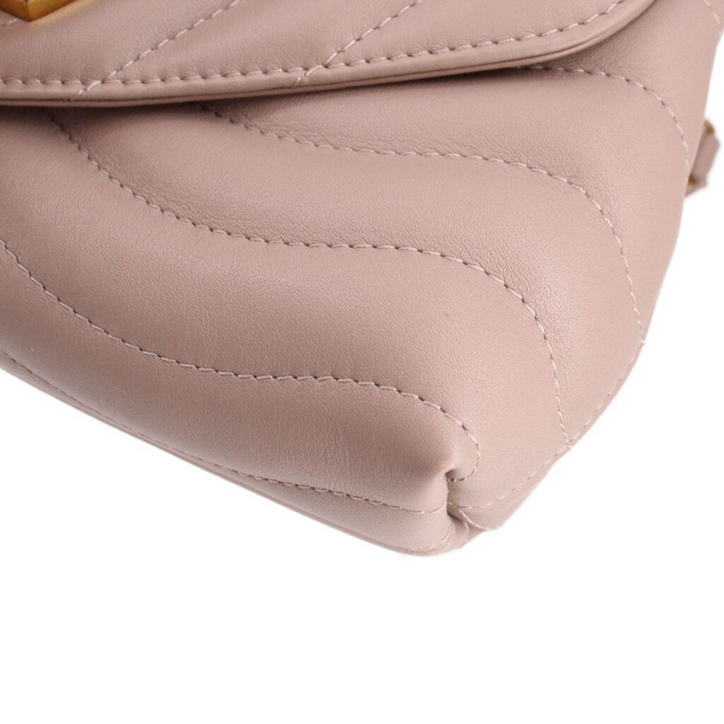 Taupe leather shoulder bag corner detail with visible stitching and smooth edges