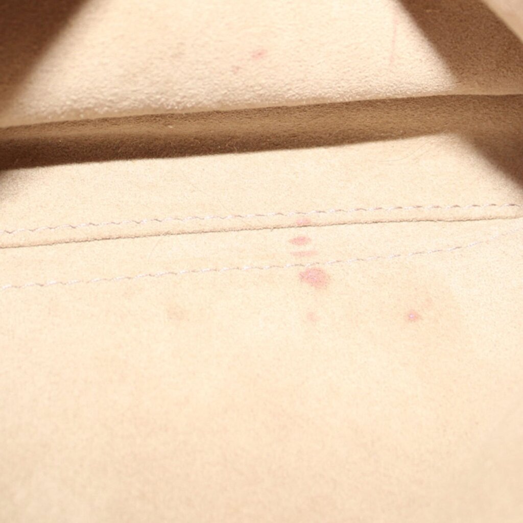 Taupe interior lining close-up with stitched seam and subtle marks