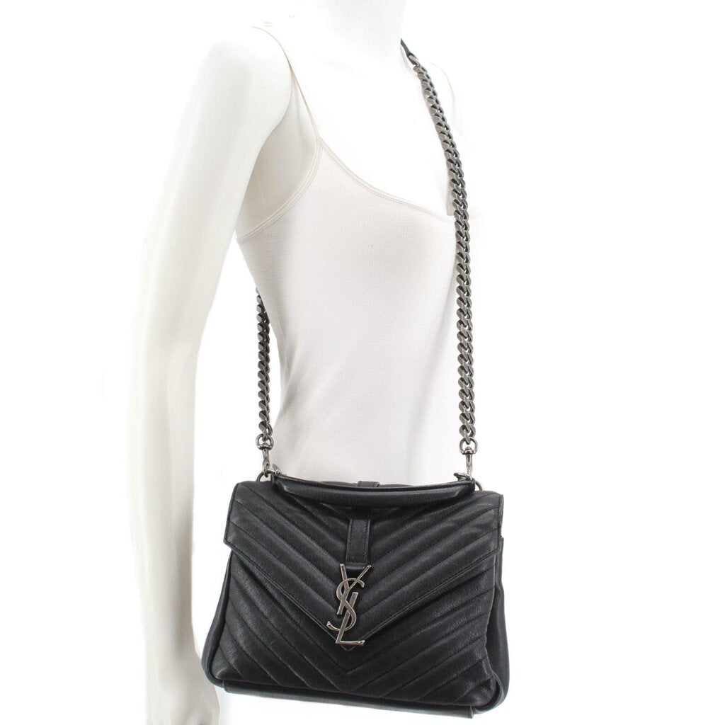 SAINT LAURENT quilted black medium crossbody bag worn on model with chain strap