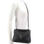 SAINT LAURENT quilted black medium crossbody bag worn on model with chain strap