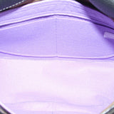 Black saddle crossbody bag interior close-up with fabric lining and seam stitching