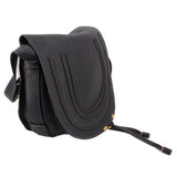 Black saddle crossbody bag side view with stitched trim and adjustable strap