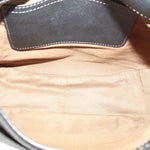 Black saddle crossbody bag interior view with fabric lining and stitched opening