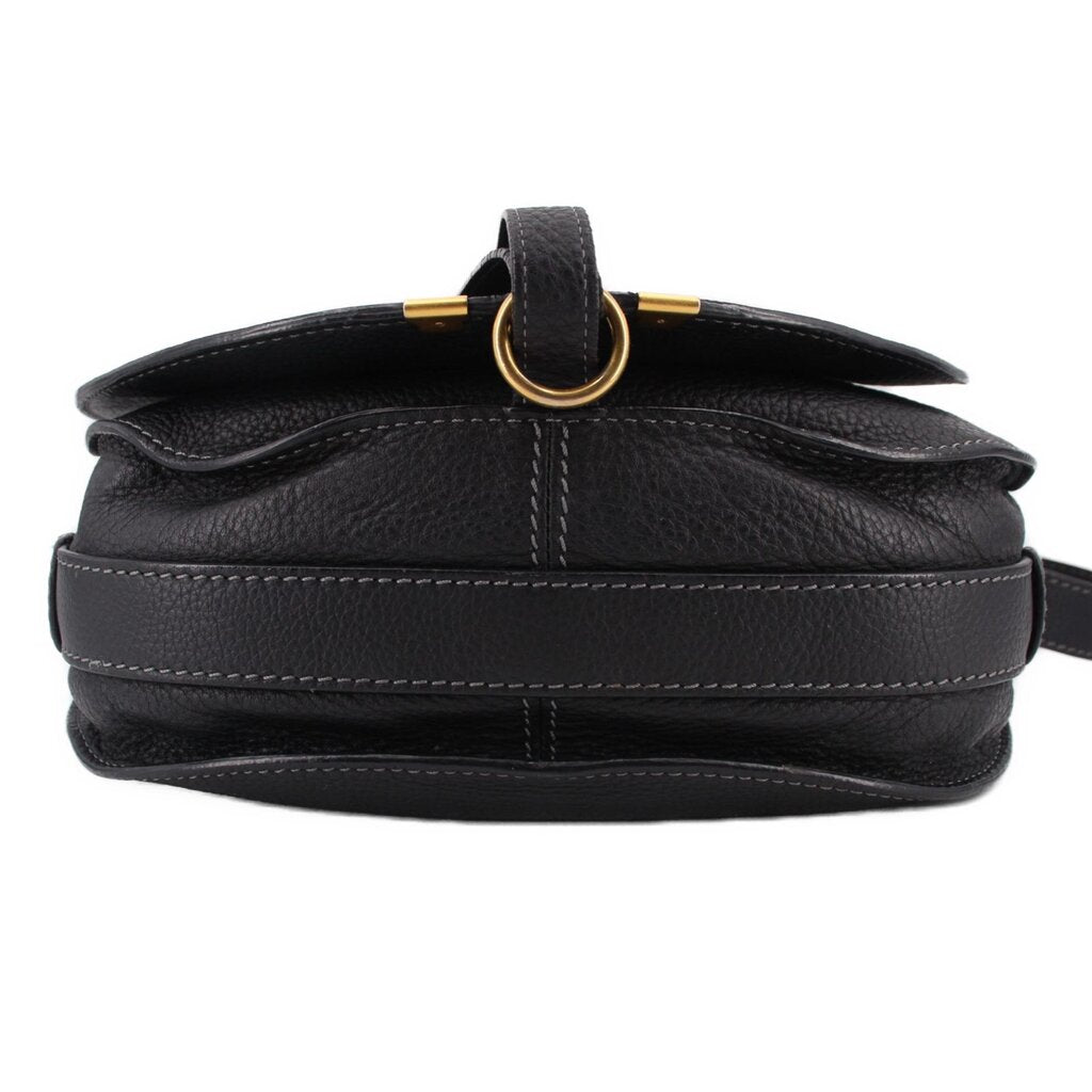 Black saddle crossbody bag top view with gold-tone ring hardware and strap