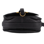 Black saddle crossbody bag top view with gold-tone ring hardware and strap