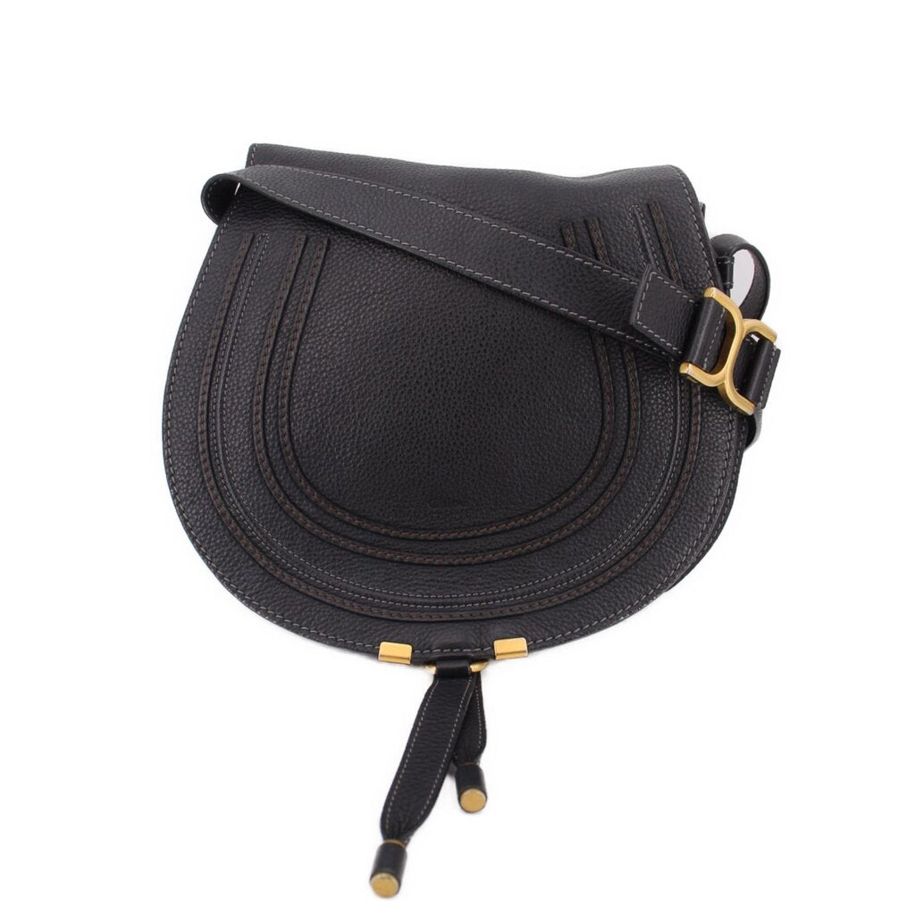 Black saddle crossbody bag with gold-tone buckle and adjustable strap