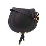 Black saddle crossbody bag with gold-tone buckle and adjustable strap