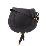 Black saddle crossbody bag with gold-tone buckle and adjustable strap