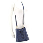 COACH ROWAN blue bucket crossbody bag on mannequin, adjustable strap, gold hardware