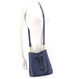 COACH ROWAN blue bucket crossbody bag on mannequin, adjustable strap, gold hardware